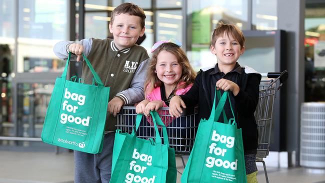 Cooper and Savannah Edgar and Kody Vaneck with their green bags at Woolworths Waterford. Picture: AAP/Jono Searle