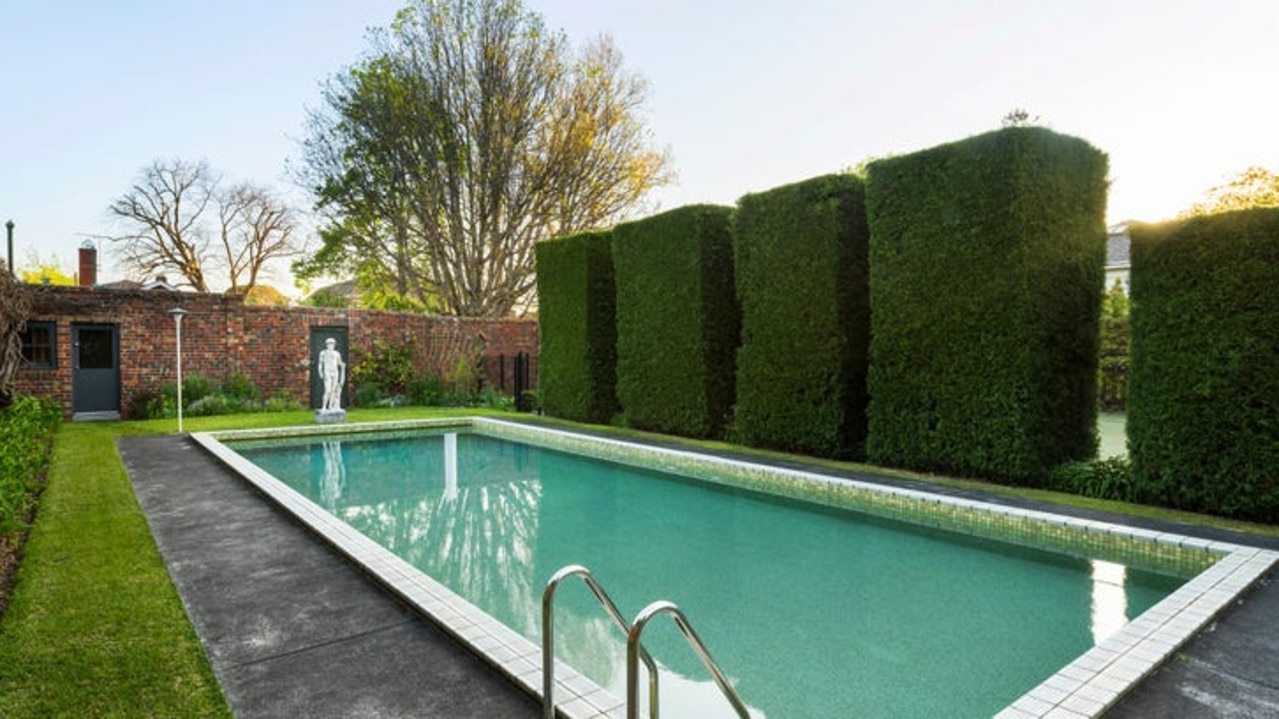 The pool lies behind a 100-year-old wisteria hedge.