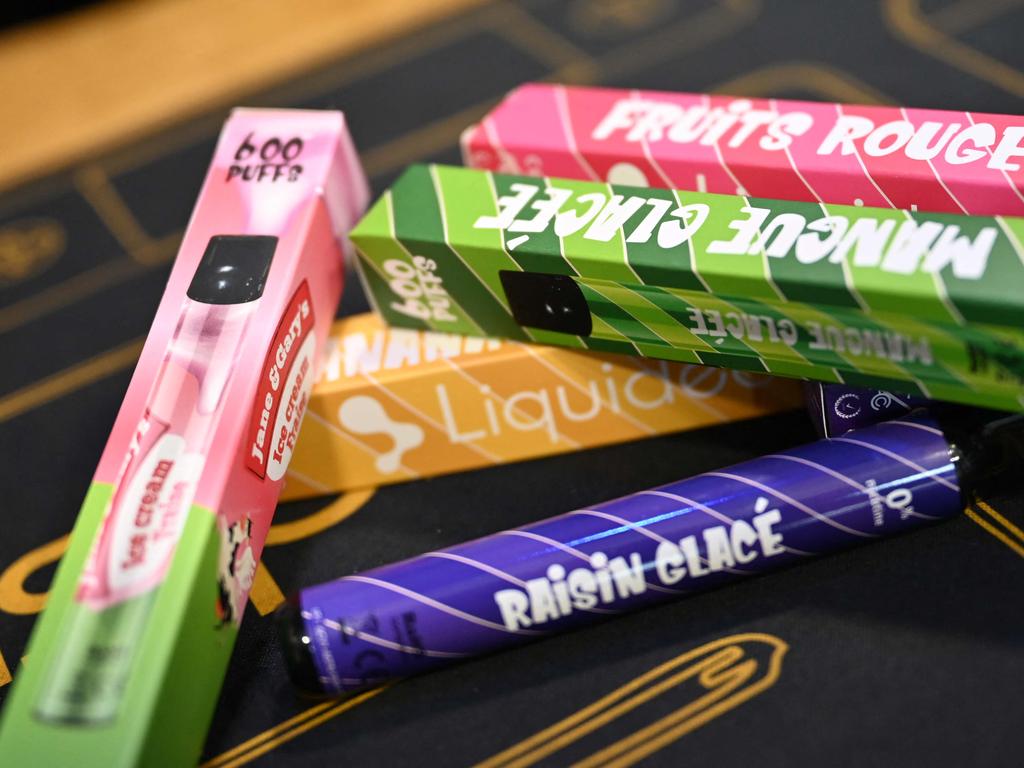 A picture shows boxes of "puffs" disposable electronic cigarettes displayed on table at La Vapotitheque store in Bethune, northern France, on May 25, 2022. - The "puffs" disposable electronic cigarettes, with their tangy or fruity flavours and a sold at around 8 and 12 euros at tobacconists, on websites or in supermarkets, are a hit with some teenagers, but worry doctors and health authorities. They come in a wide range of flavours and offer some 600 "puffs" for a nicotine level of between 0 and 20 mg/ml. (Photo by DENIS CHARLET / AFP)