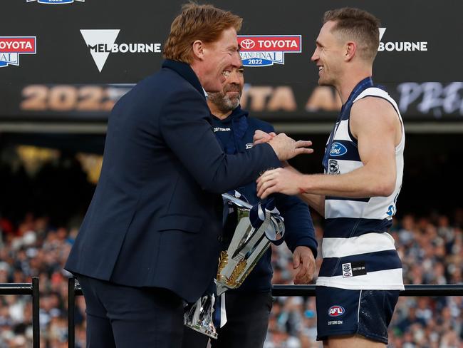 MELBOURNE, AUSTRALIA - SEPTEMBER 24: Cameron Ling presents the Cup to Chris Scott, Senior Coach of the Cats and Joel Selwood of the Cats during the 2022 Toyota AFL Grand Final match between the Geelong Cats and the Sydney Swans at the Melbourne Cricket Ground on September 24, 2022 in Melbourne, Australia. (Photo by Michael Willson/AFL Photos via Getty Images)