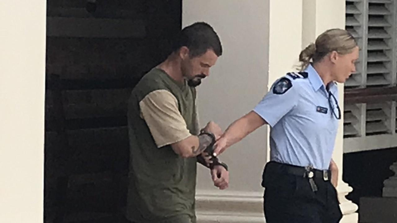 Graham Robert Hamilton is led away from the Gympie District Court after pleading guilty to three child sex offences on a five-year-old girl.