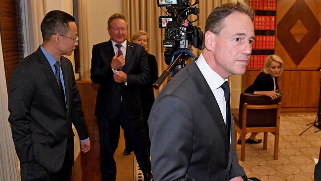 Greg Hunt leaves Wednesday’s press conference followed by Victoria and Tasmania Consul-General of China Long Zhou and Andrew Forrest. Picture: AAP.