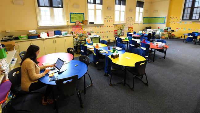 A teacher is seen in an empty class room at a primary school in Melbourne's inner north. Picture: AAP