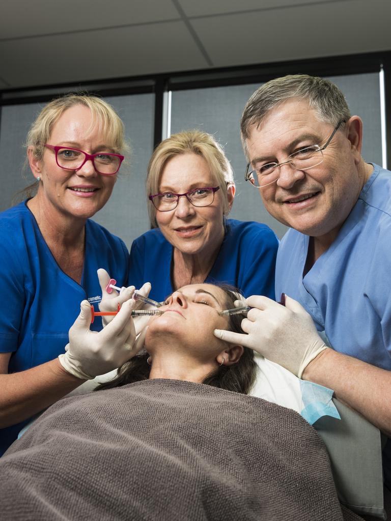 The team at Cosmetic Elegance (from left) nurse Liz Waugh, nurse Vicki Piets and Dr Eddie Roos have fun with staff member Jo Aspromourgos as they are named the best cosmetic injectors in The Chronicle's 2021 Best of Toowoomba series, Thursday, October 21, 2021. Picture: Kevin Farmer