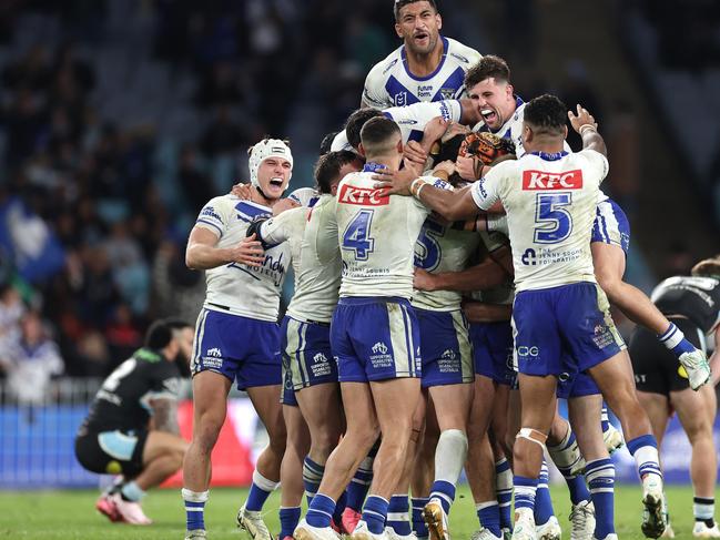 SYDNEY, AUSTRALIA - JUNE 28:  Matt Burton of the Bulldogs celebrates with team mates after kicking a golden point field goal in extra time to win the round 17 NRL match between Canterbury Bulldogs and Cronulla Sharks at Accor Stadium on June 28, 2024, in Sydney, Australia. (Photo by Cameron Spencer/Getty Images)