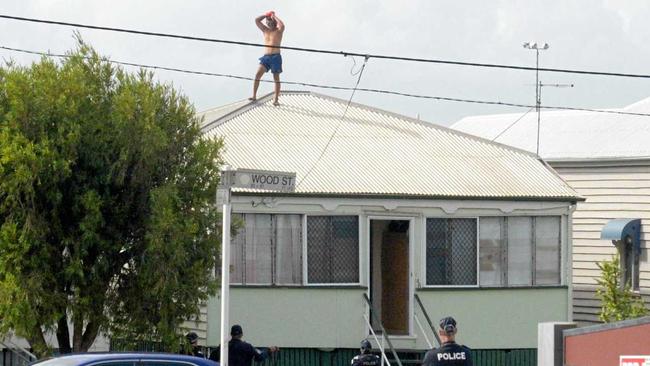 Rockhampton police try to talk a man down off a roof in Wood St, Depot Hill. Picture: Jann Houley