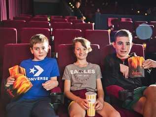 Phoenix Taylor, Hudson Strong and Taj Taylor found the front seats for their first trip to the movies for a long time. Picture: Nev Madsen