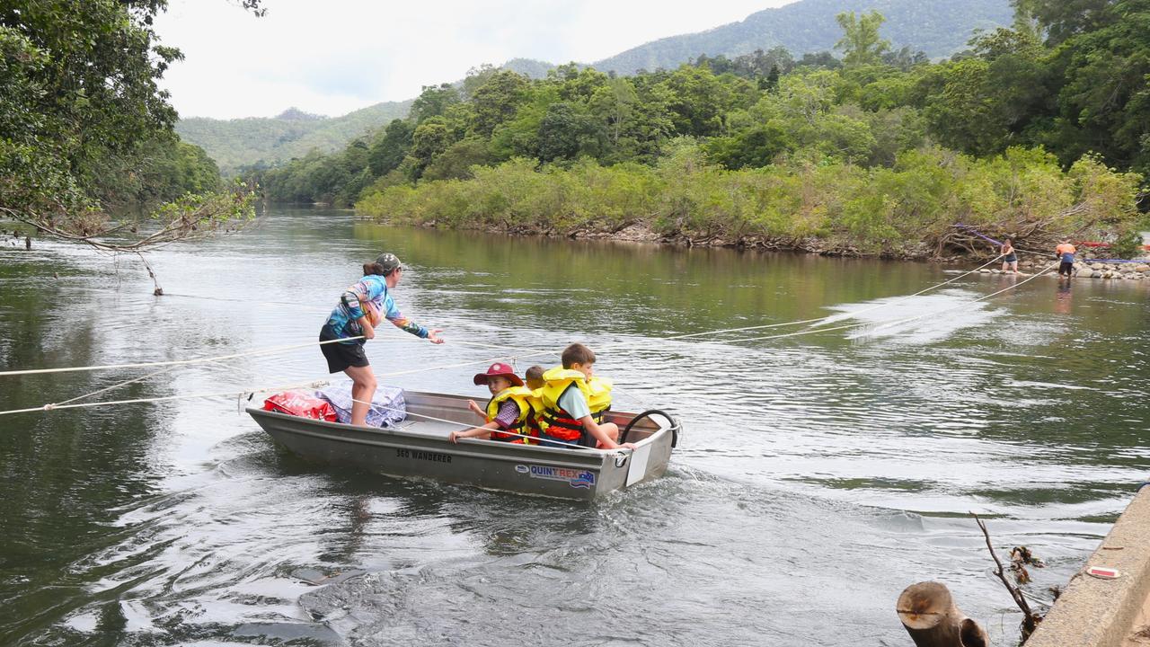 Earlier this year Goldsborough resident Sonya Bielek pulled a small boat across the Mulgrave River to complete the daily school run after flood waters washed the Fisheries Bridge away on December 18. Picture: Peter Carruthers