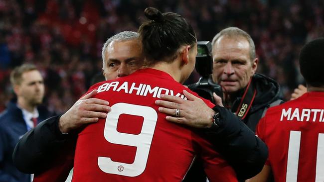 Manchester United's Swedish striker Zlatan Ibrahimovic embraces Manchester United's Portuguese manager Jose Mourinho.