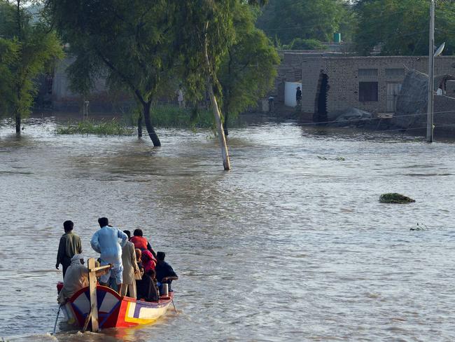 Pakistani residents are evacuated by boat to dry land in Jhang, central Punjab province.