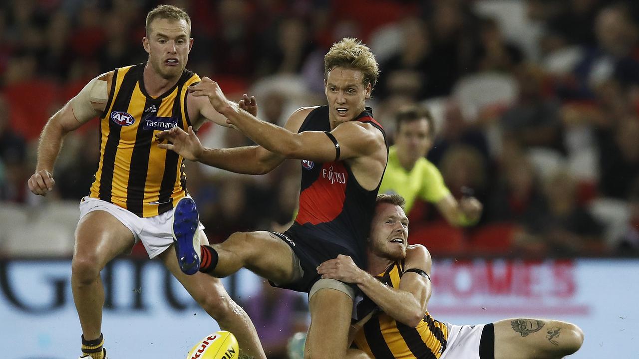 Darcy Parish of the Bombers is tackled by Blake Hardwick of the Hawks. Picture: Daniel Pockett