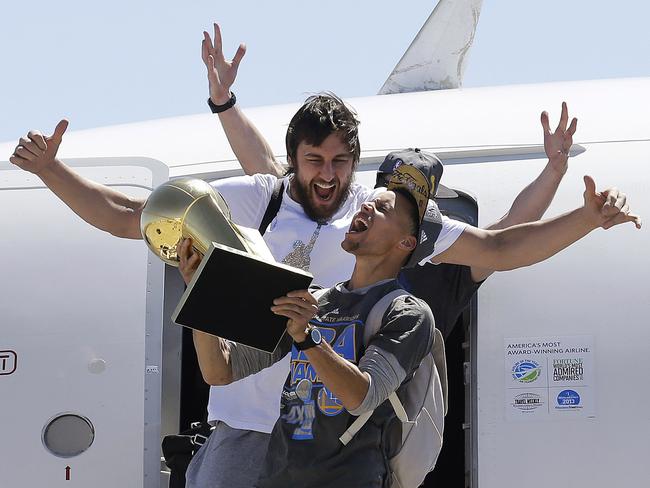 Andrew Bogut celebrates with Steph Curry after winning the NBA title last season.