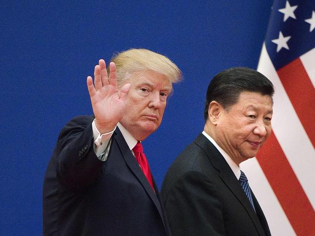 (FILES) In this file photo US President Donald Trump (L) and China's President Xi Jinping leave a business leaders event at the Great Hall of the People in Beijing on November 9, 2017. - Donald Trump pleaded with China's leader Xi Jinping for help to win re-election in 2020, the US president's former aide John Bolton writes in an explosive new book, according to excerpts published June 17. (Photo by Nicolas ASFOURI / AFP)