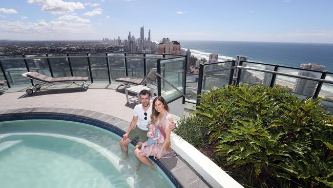 Jason and Vanessa Papillo with three-month-old baby Ivy enjoy the pool on the roof of Wave Broadbeach Picture: Richard Gosling