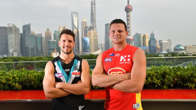 Port Adelaide skipper Travis Boak and Gold Coast Suns co-captain Steven May pose for a photograph overlooking the skyline in Shanghai, China this week. Picture: AAP Image/David Mariuz