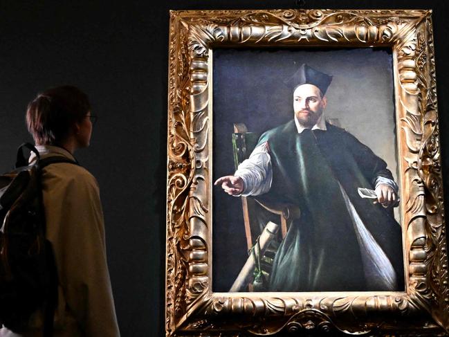 A visitor looks at the private collection and never previously shown to the public painting "Portrait de Maffeo Barberini" by Italian master Caravaggio at the Gallerie Nazionali di Arte Antica in the Barberini palace in Rome on November 22, 2024. (Photo by Alberto PIZZOLI / AFP) / RESTRICTED TO EDITORIAL USE - MANDATORY MENTION OF THE ARTIST UPON PUBLICATION - TO ILLUSTRATE THE EVENT AS SPECIFIED IN THE CAPTION