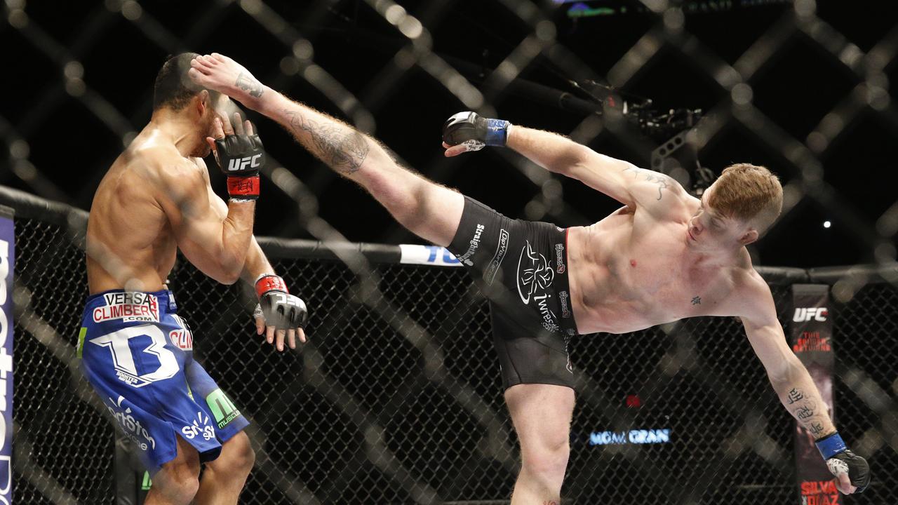 Paul Felder kicks Danny Castillo during their lightweight mixed martial arts bout at UFC 182 on Saturday, Jan. 3, 2015, in Las Vegas. (AP Photo/John Locher)