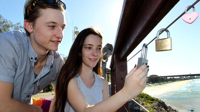 Nathan Brown and Sheridan Pearce look at the love locks at Miami headland. Picture: Mike Batterham