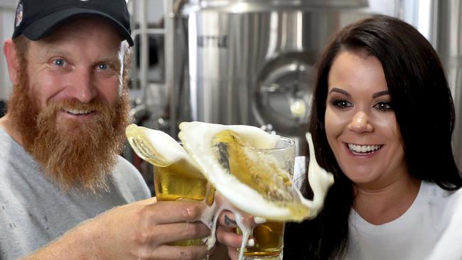 Brewer Craig Basford with brew venue staffer Amy Lowe, testing their beer at Big Shed's Royal park Brewery. Picture: Dean Martin