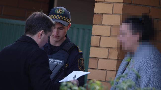 Police and protective security personnel speak to neighbours in the area. Picture: Russell Millard