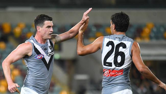 Tom Rockliff and Riley Bonner celebrate a goal against Collingwood. Picture: Quinn Rooney/Getty Images.