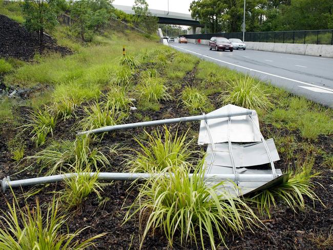 A damaged road sign at the Klumpp Road exit of the Southeast Freeway where the brutal 2004 murder took place. Picture: Steve Pohlner