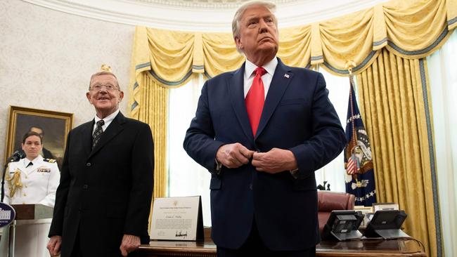 Lou Holtz waits to be awarded the Medial of Freedom by Donald Trump during a ceremony in the Oval Office. Picture: AFP.