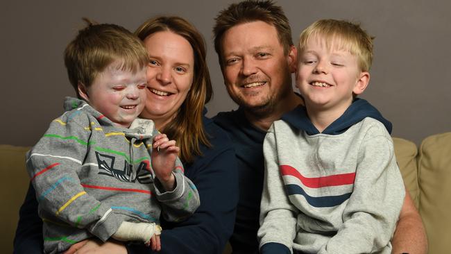 Harrison Pennicott relaxes at home with parents Leesa and Jamie and brother Miller before he enters The Royal Children’s Hospital for a bone-marrow transplant and chemotherapy. Picture: JAMES ROSS.