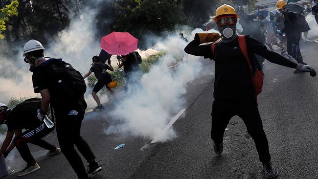 Protesters hurl objects at the police during a demonstration in support of the city-wide strike and to call for democratic reforms at Tai Po residential area in Hong Kong on Monday. Picture: Tyrone Siu/Reuters