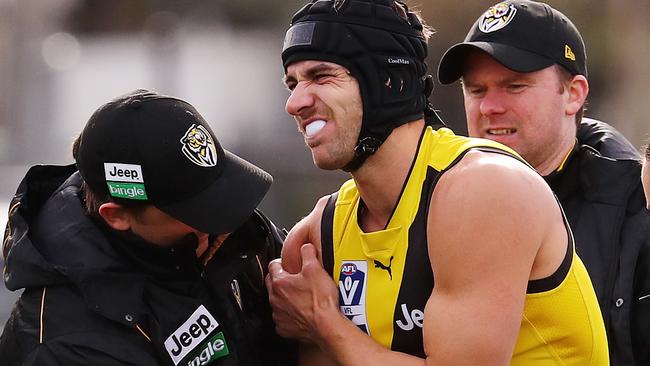 Richmond’s Ben Griffiths in the hands of medicos. Picture: Michael Klein
