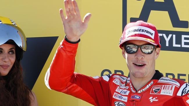 FILE - In this Sunday, Sept. 19, 2010 file photo, MotoGP Ducati rider Nicky Hayden of the U.S. waves on the podium after finishing third at the MotoGP Aragon Motorcycle Grand Prix at the Motorland racetrack in Alcaniz, Spain. The Maurizio Bufalini Hospital has announced that American motorcycle racer Nicky Hayden has died, five days after being hit by a car while training on his bicycle Hayden was 35. (AP Photo/Paul White, File)