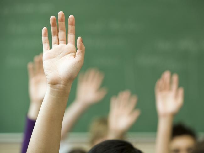 Hands raised in classroom  Picture: istock