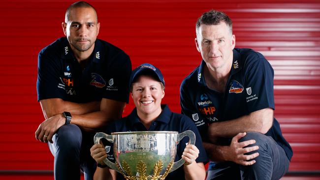 Bec Goddard holds the 2017 AFLW Premiership Cup with 2018 season assistants Andrew McLeod, left, and Peter Caven. Picture: Matt Turner.