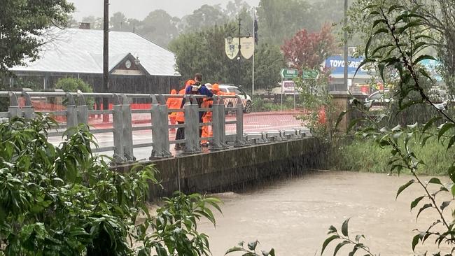 Local SES units are working to flatten the sides of the Stonequarry Bridge in Picton, which is prone to flooding. Picture: Adelaide Lang