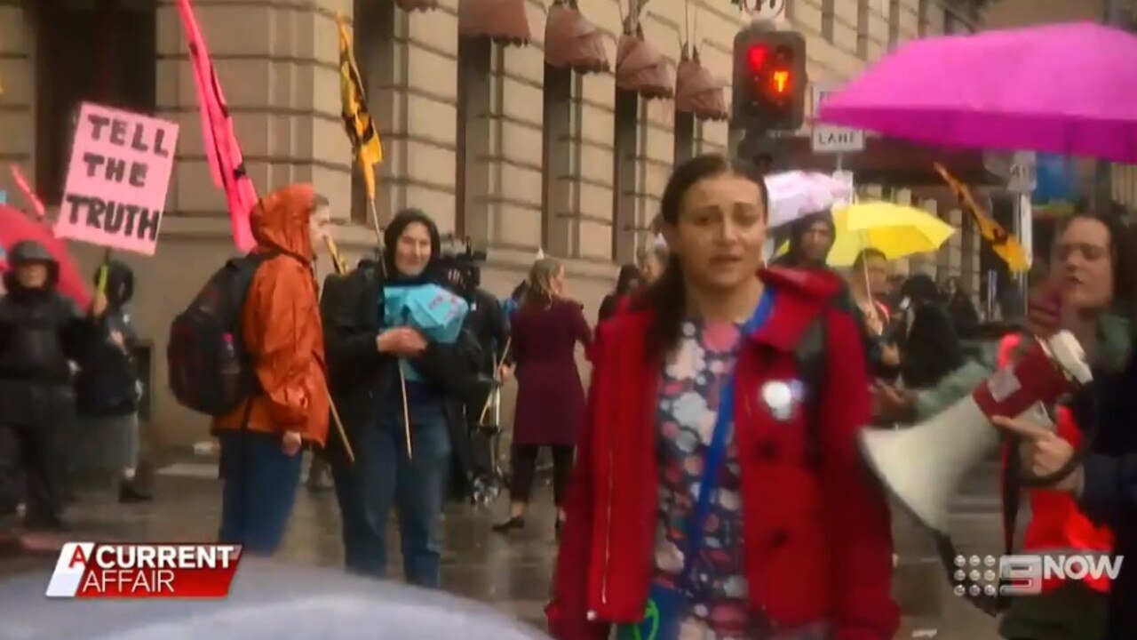 But a lone protester jumps in front of her car.