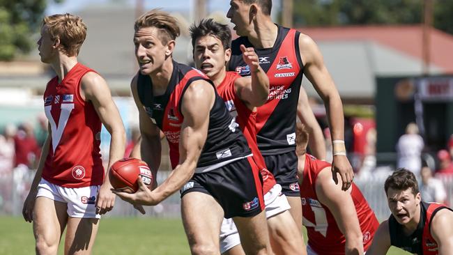 Chris Schmidt gets a handball away for West under pressure on Saturday. Picture: AAP/Mike Burton