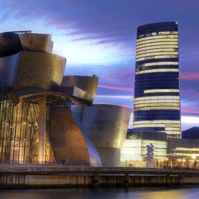 The Iberdrola Tower, right, headquarters of the company, in Bilbao, Spain. It is in the neighbourhood of the Guggenheim Museum.