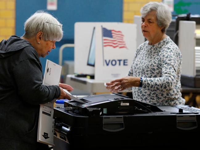 People put their ballots in the tabulation machine for the Michigan primary. Picture: AFP