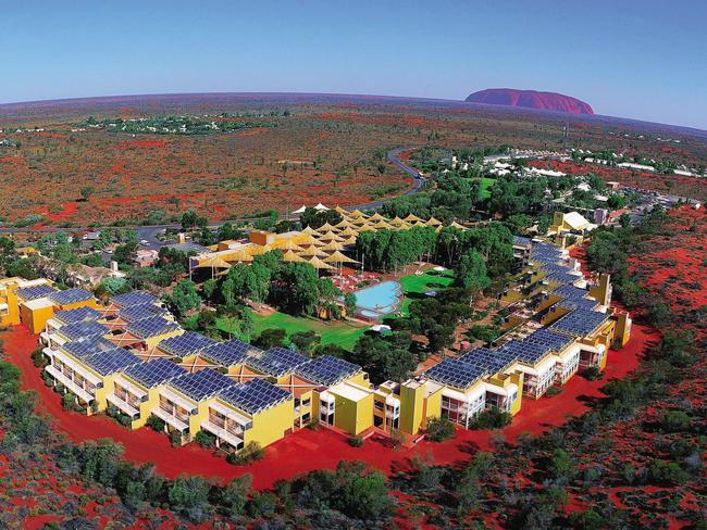 An aerial shot of Ayers Rock Resort with Uluru in the background. Picture; Voyages Tourism Australia