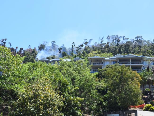 Firefighters are dampening down hotspots after a fire broke out in Airlie Beach on Monday.