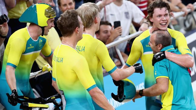 Decker (right) celebrates with his team pursuit riders after they broke the world record at the Gold Coast Commonwealth Games. Picture: Matt King/Getty