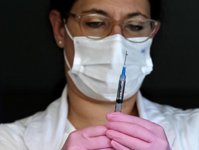 An Israeli nurse prepares to administer a Covid booster shot. Picture: AFP