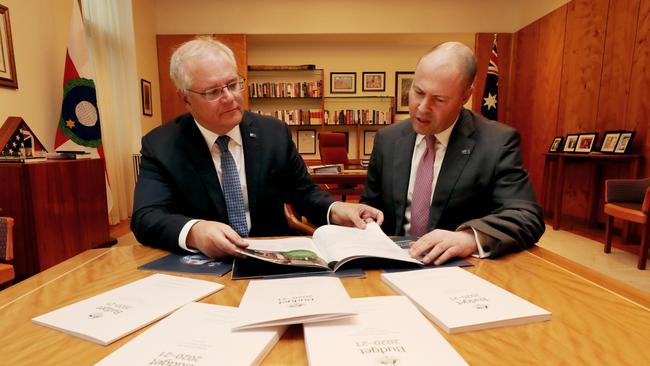 Prime Minister Scott Morrison with Treasurer Josh Frydenberg look over the budget papers. Picture: Adam Taylor