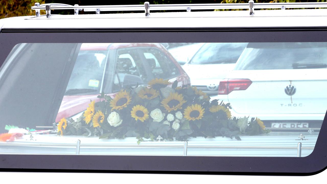 Olyvia Cowley’s coffin was loaded back into a waiting vehicle, still adorned with bright sunflowers. Picture: NCA NewsWire/ Richard Gosling