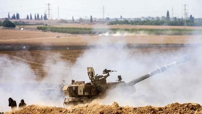 An Israeli army self-propelled howitzer fires rounds near the border with Gaza in southern Israel.Picture: AFP