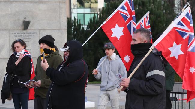 Some wore scarfs to cover their faces, but many were unmasked. Picture: David Crosling