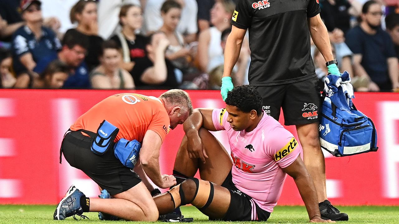 BRISBANE, AUSTRALIA - SEPTEMBER 25: Tevita Pangai Junior of the Panthers receives attention from the trainer during the NRL Preliminary Final match between the Melbourne Storm and the Penrith Panthers at Suncorp Stadium on September 25, 2021 in Brisbane, Australia. (Photo by Bradley Kanaris/Getty Images)
