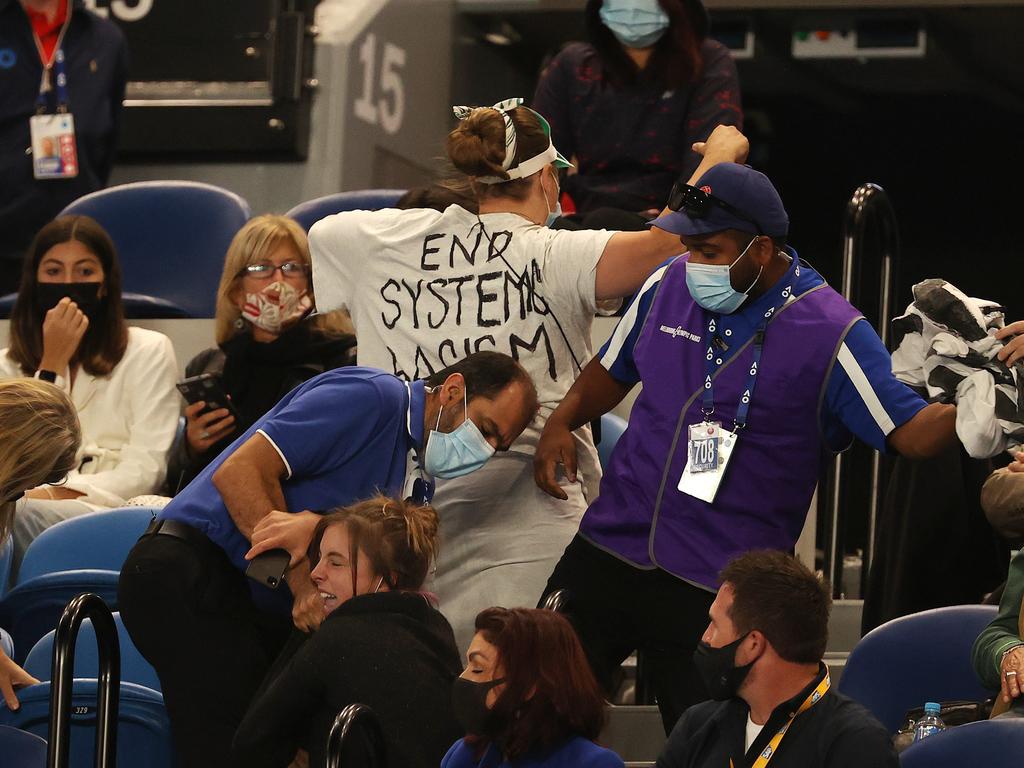 Protesters evicted from Rod Laver Arena during the second set.