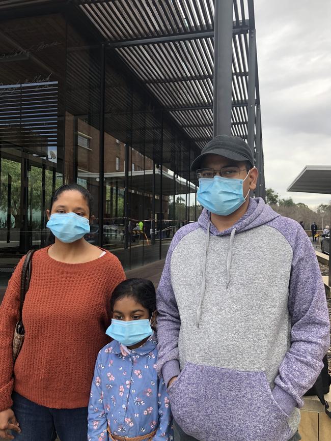 ‘Scared’: Parramatta family Sreeveena and Vemanna Reddy with their daughter Diya at Parramatta Community Health Centre in Jeffery House for coronavirus testing.