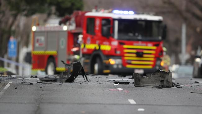 Wreckage is strewn across the street after the fiery blaze. Picture: David Crosling